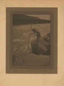 Original early 1900s platinum print photograph of an Native American fishing by Edward C. Curtis.  This one has a more brownish tone plus foxing to the paper.
